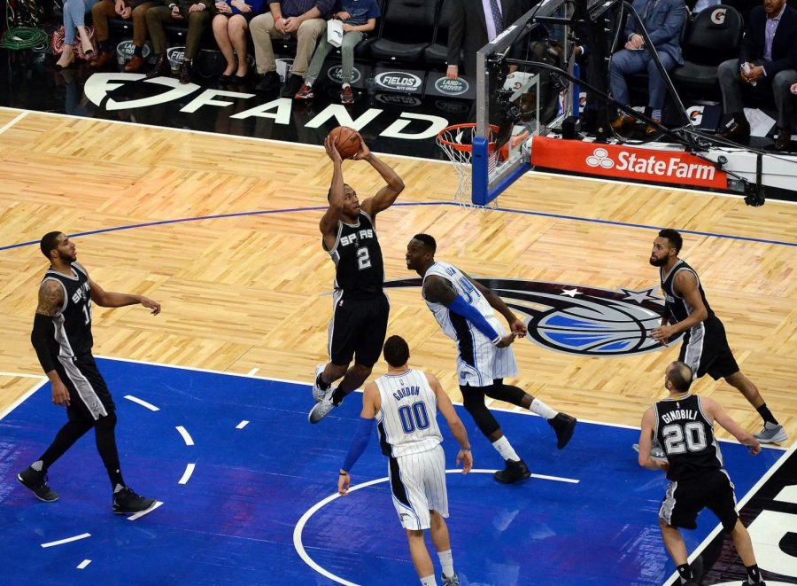 Kawhi Leonard dunks over the Orlando Magic