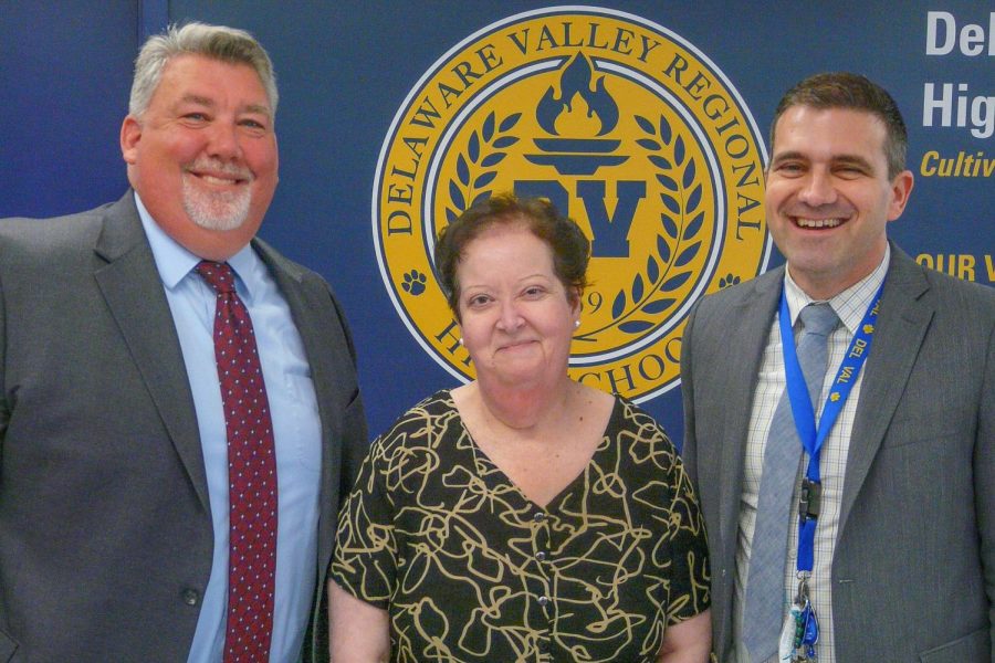 Superintendent McKinney (left) and principal Kays (right) honored Wolsiefer at the latest Board of Education meeting.