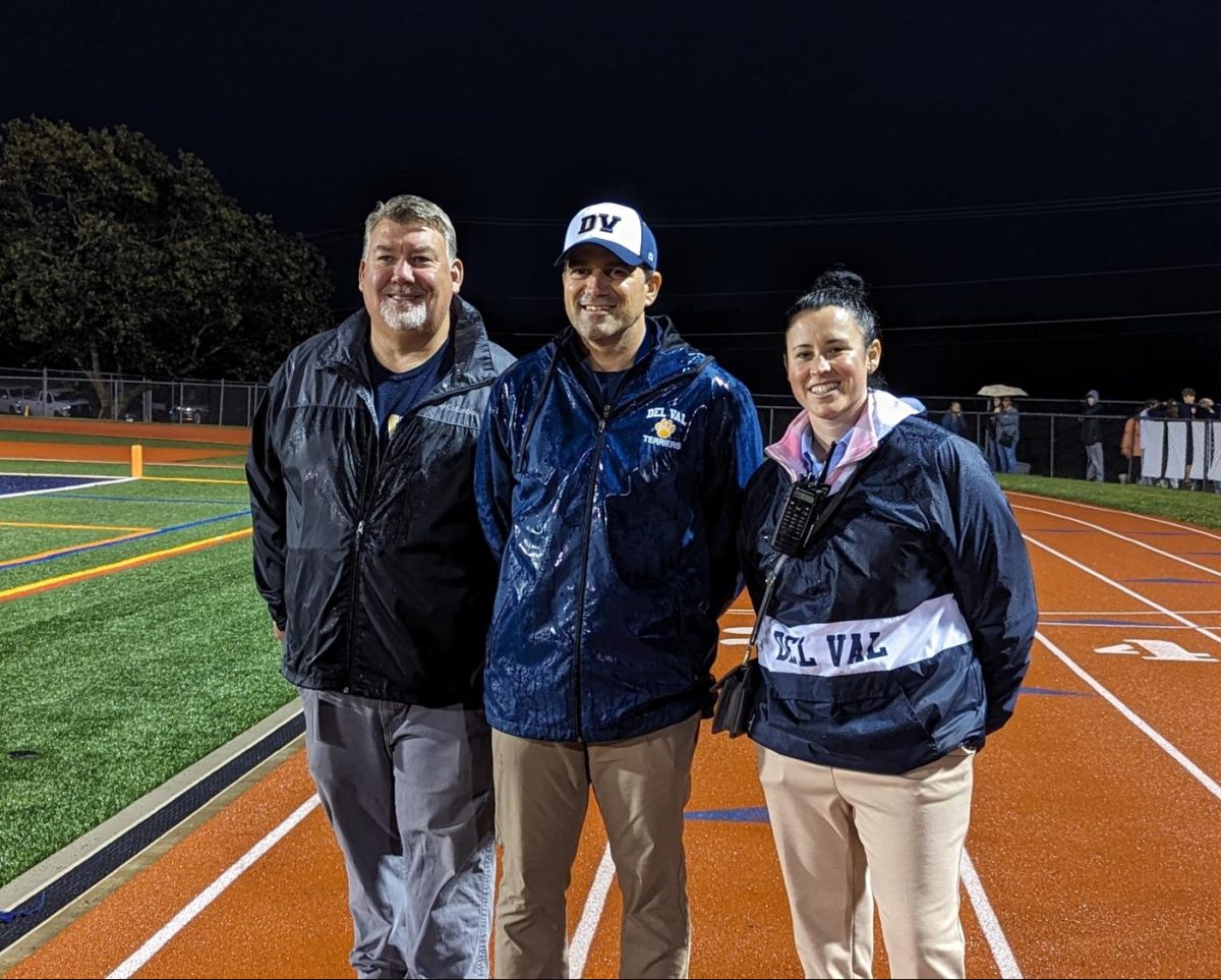 Dr. Gilbert (right) with Superintendent McKinney (left) and Principal Kays (center) at the Homecoming football game.