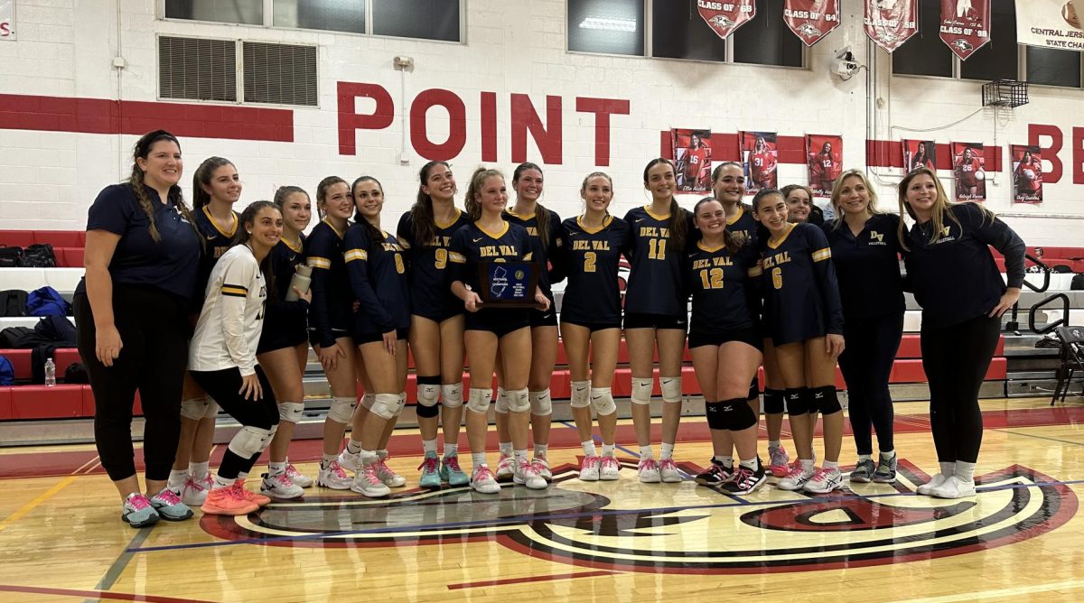 The Del Val Volleyball team holding sectional trophy after its victory.