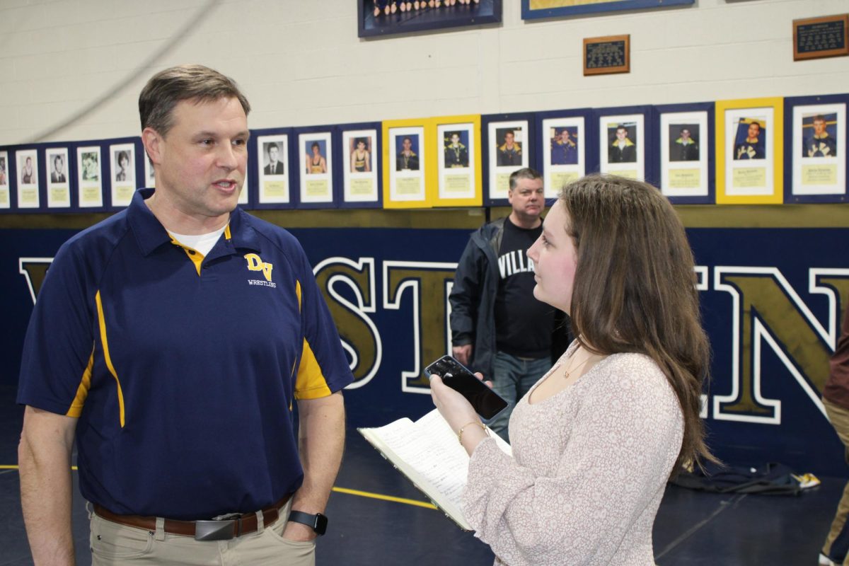 Assistant Sports editor Ella Genovese interviews wrestling coach Andy Fitz after the Gold Rush