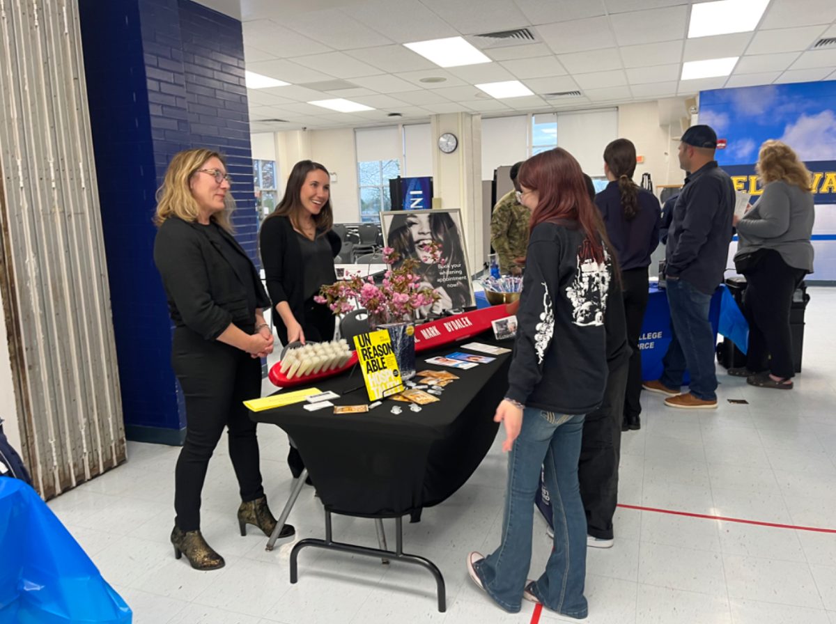 Del Val students talking with vendor at job fair