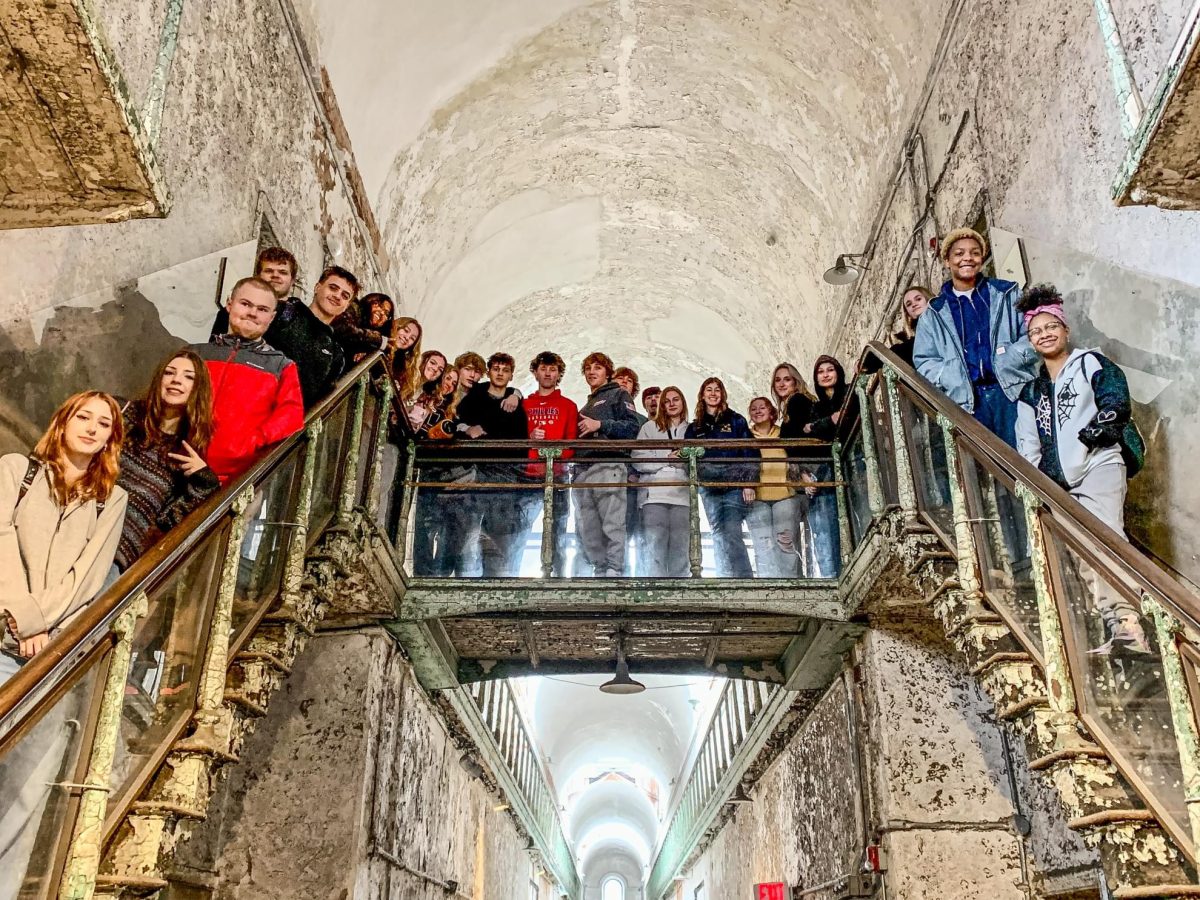 Students posing for a group photo on one of the penitentiarys staircases.