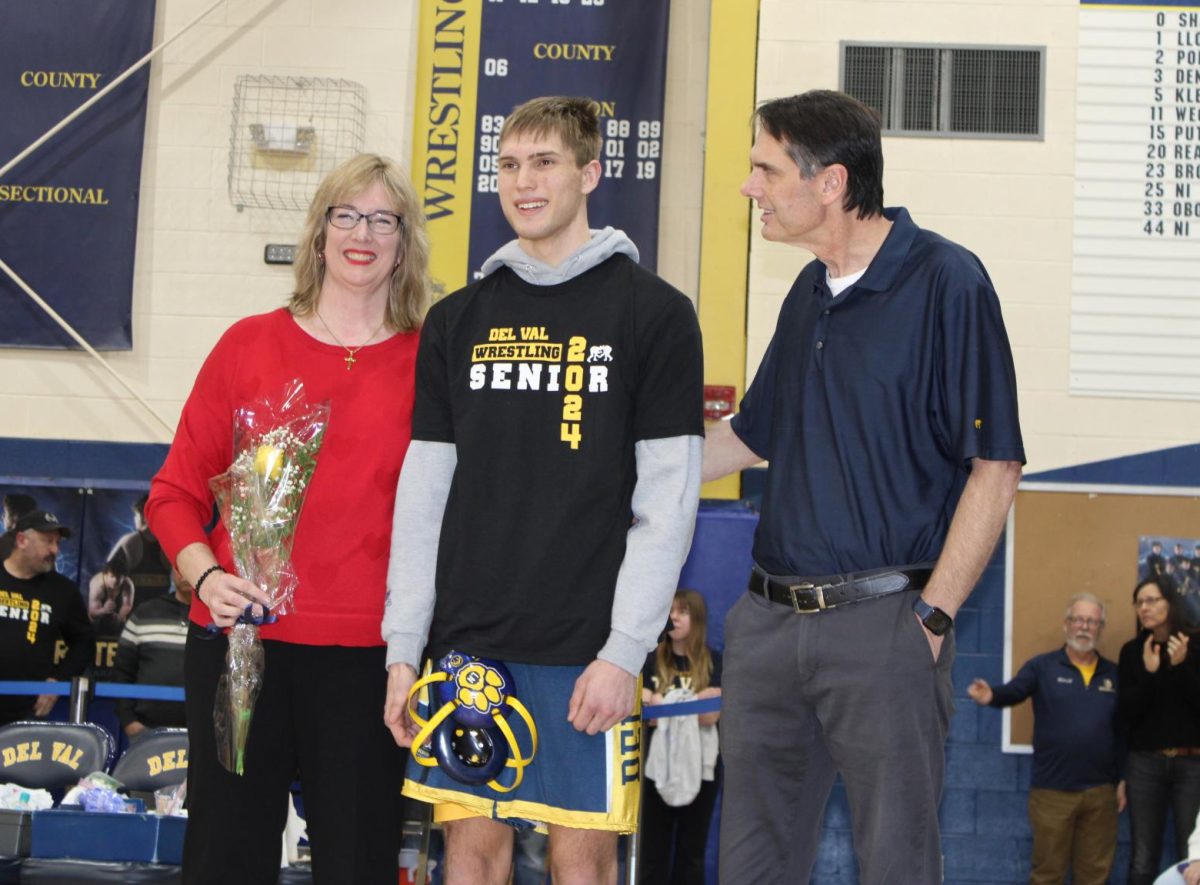 Anderson Olcott joined by his parents at DVR Wrestling Senior Night.