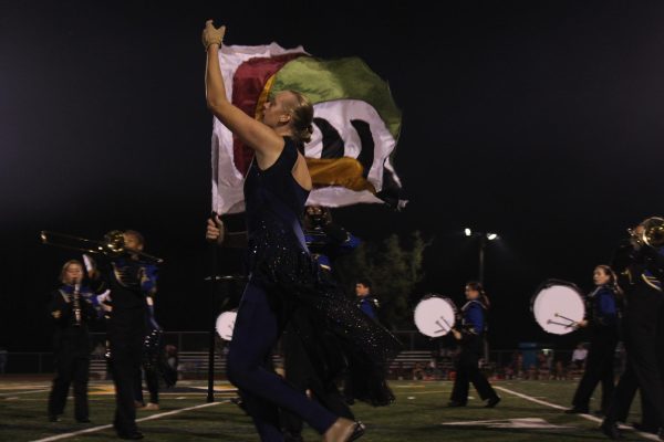 Senior Cayden Puttlitz performing in Del Val's color guard on Homecoming night.