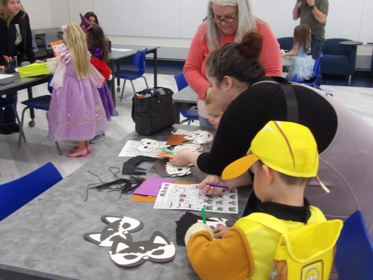 Children worked on arts and crafts to celebrate the Halloween season, including decorating masks.