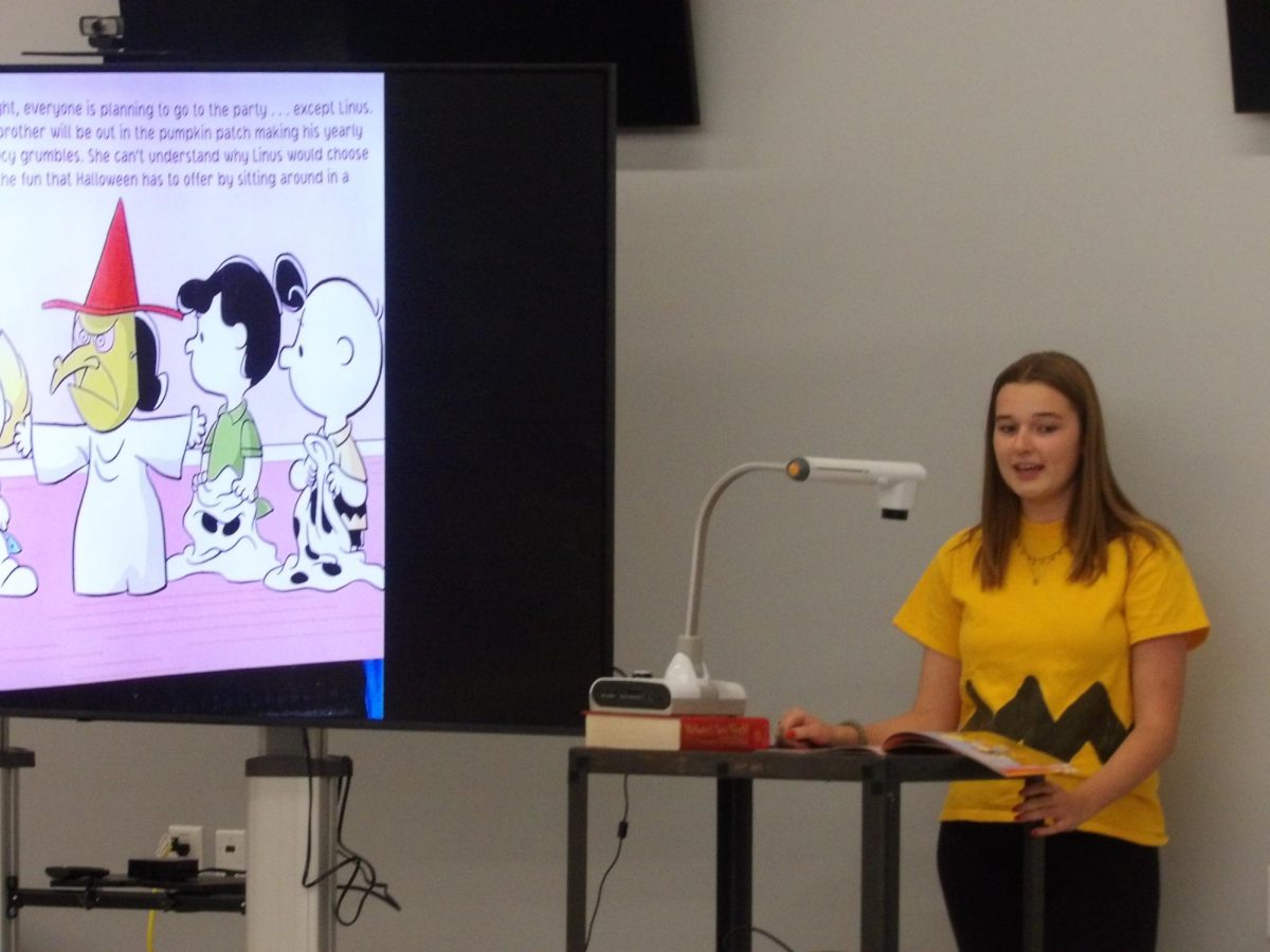 Adrienne Wolfram, a member of Thespians and the Commons Student Advisory Group, dressed in a Charlie Brown costume while reading The Great Pumpkin Charlie Brown to set the mood for the children.