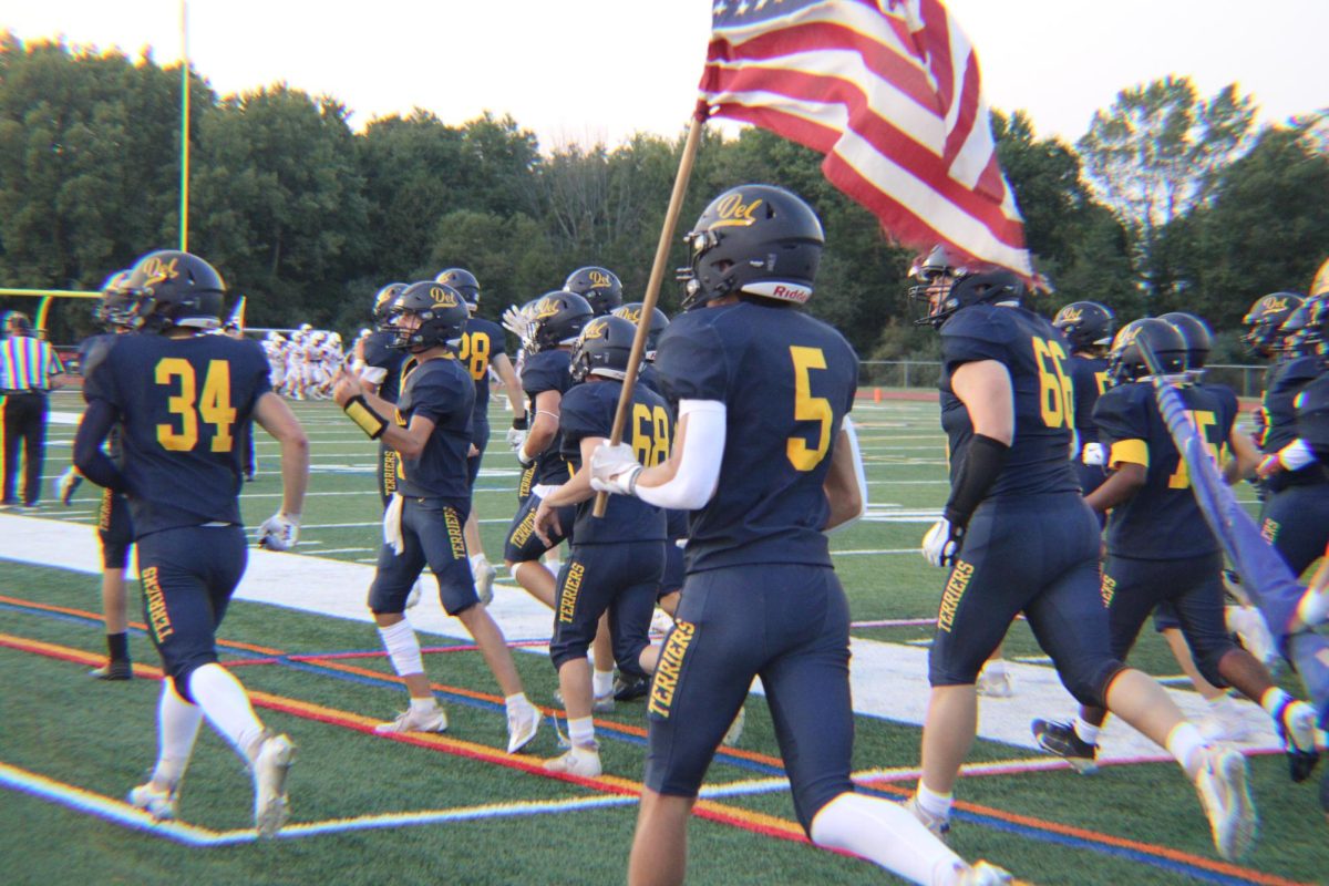 The varsity football team runs out on the field moments before facing the Bernards Mountaineers. Spirits were high ahead of the face off.