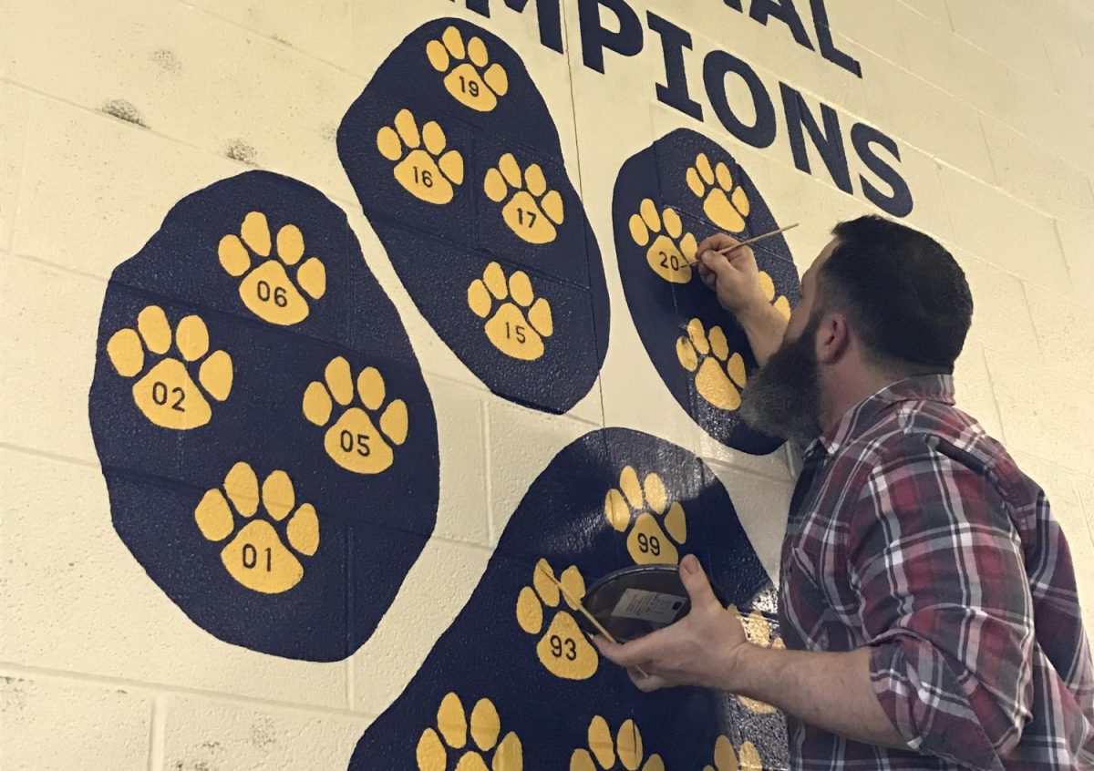 Art and ceramics teacher Jason Farnsworth makes his support of Del Val known throughout the school. He updates the wrestling team's championships on the wrestling room wall.