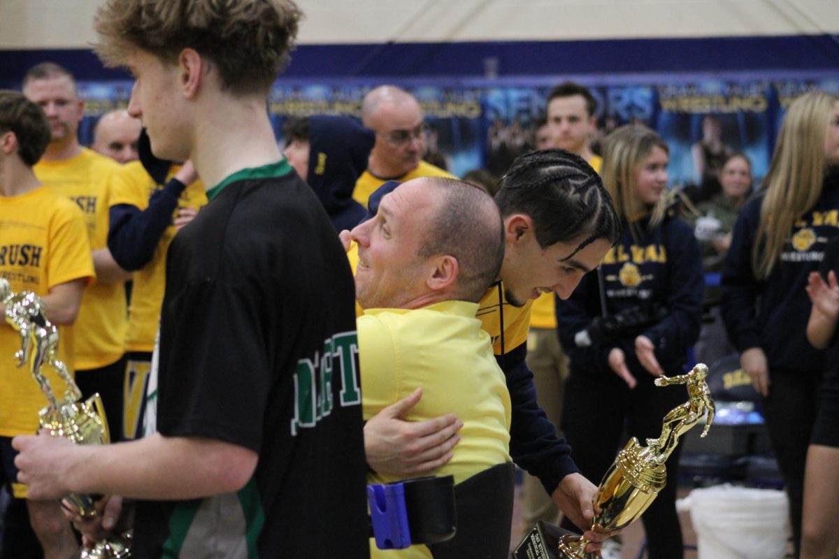 Perez hugs Phil Hutchins, the brother of Daniel, after winning. Hutchins presents the award to honor his brother and family.