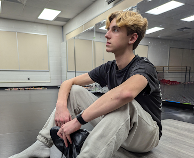 Nolen in Del Val's new dance studio as he holds his favorite pair of tap shoes.