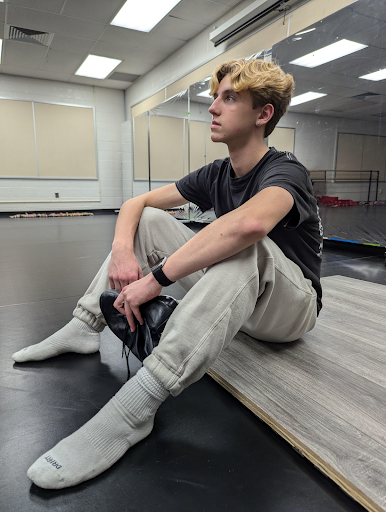 Nolen in Del Val's new dance studio as he holds his favorite pair of tap shoes.