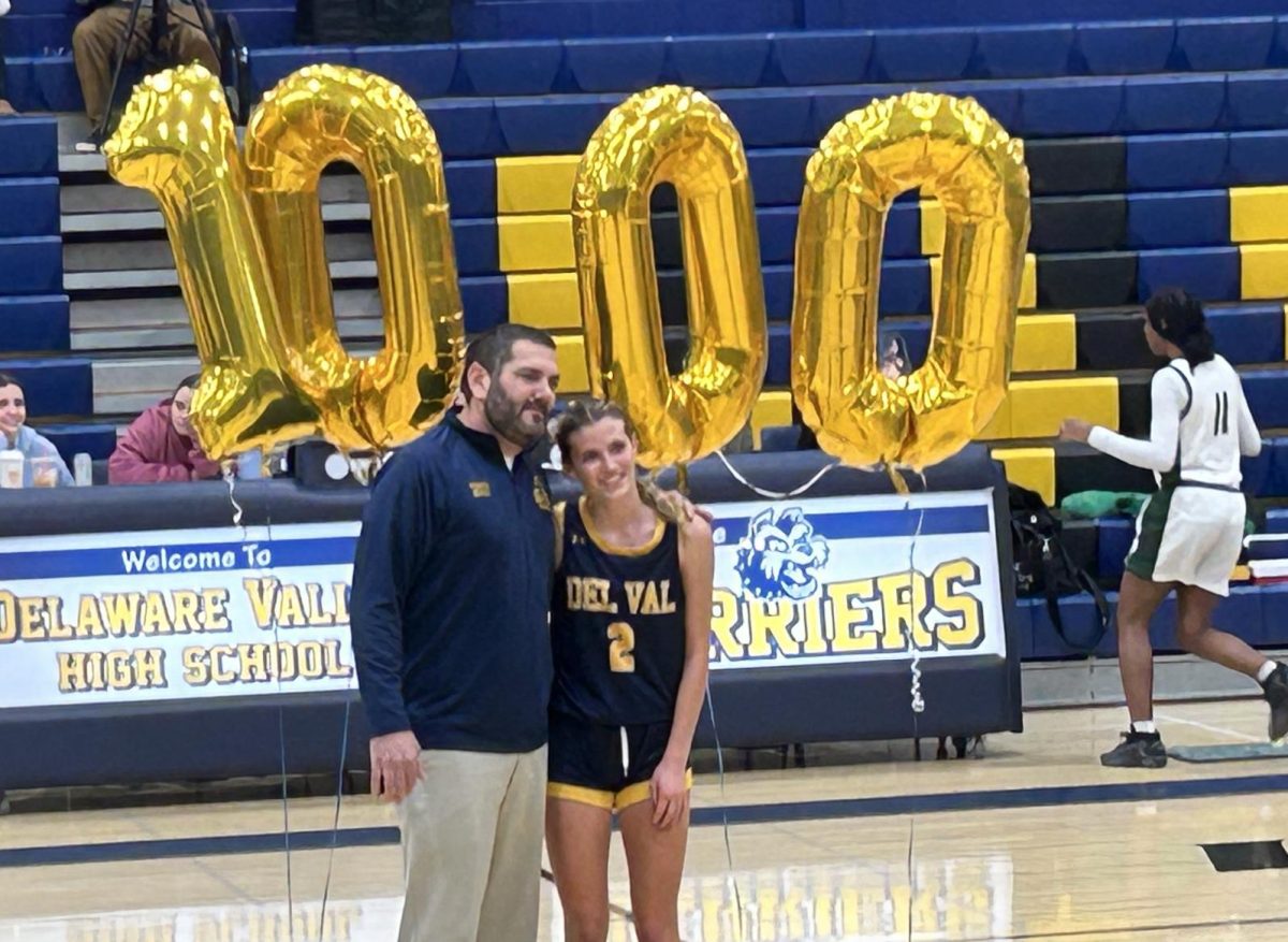 Elana Falkenstein celebrating her milestone with coach Ben Ibach.