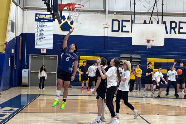 Jayden Brown goes for layup as opponents watch in awe.