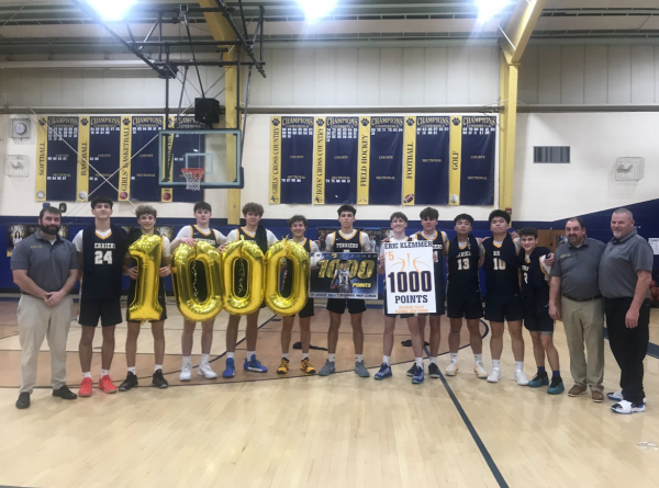 Eric Klemmer, Del Val's most recent player to reach 1,000 points, celebrating with his teammates and coaches.