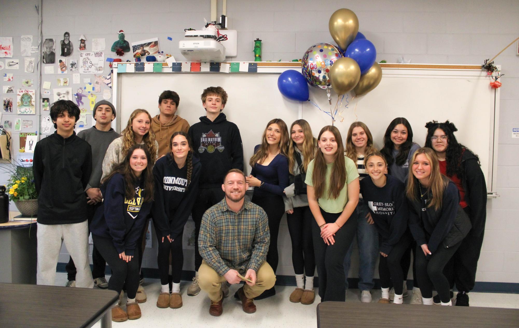 C.J. Inglin posing with his students after winning Teacher of the Year. Inglin has been teaching at his alma matter for 12 years, and this is his first time receiving this award.