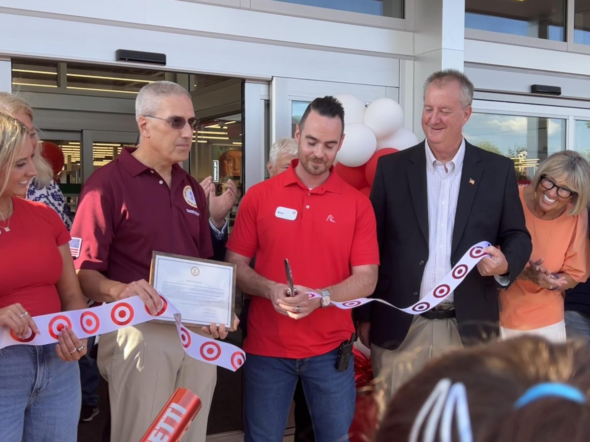 In front of Flemington Target's main entrance, store director Kevin Weick cuts the ribbon, celebrating the store's soft opening.