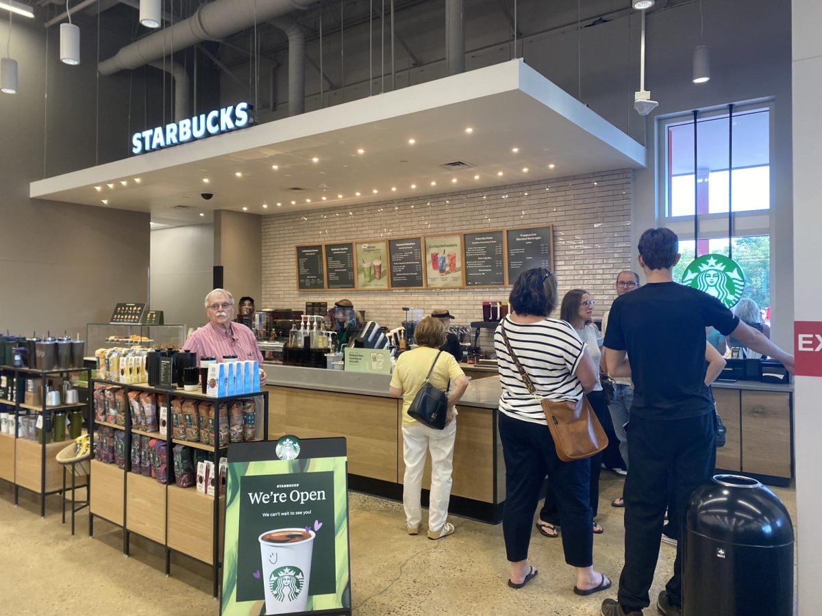 Shoppers gather in excitement to try samples and order drinks. A new Starbucks is located inside of Target Flemington.