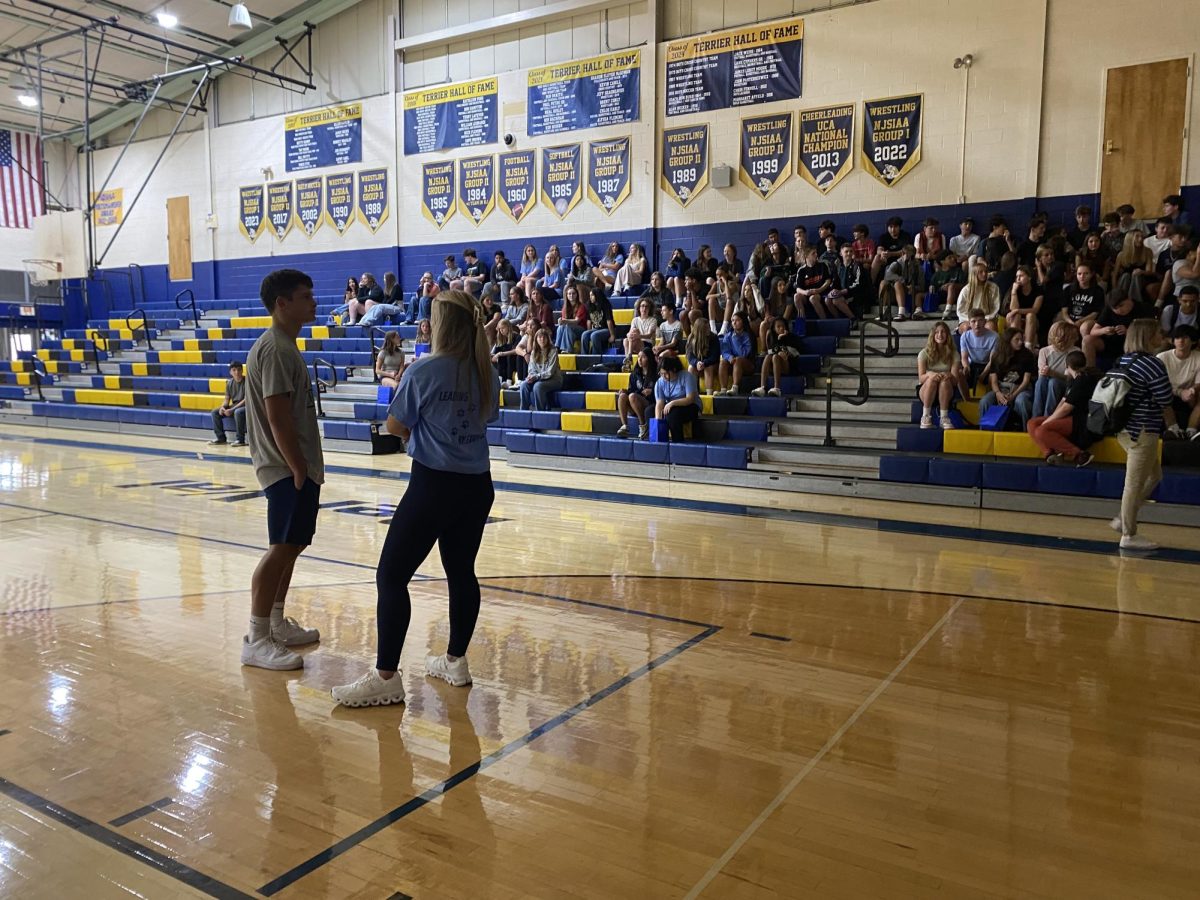 Former leaders of the Dawg Pound teach incoming students chants for athletic events and speak about etiquette during games.
