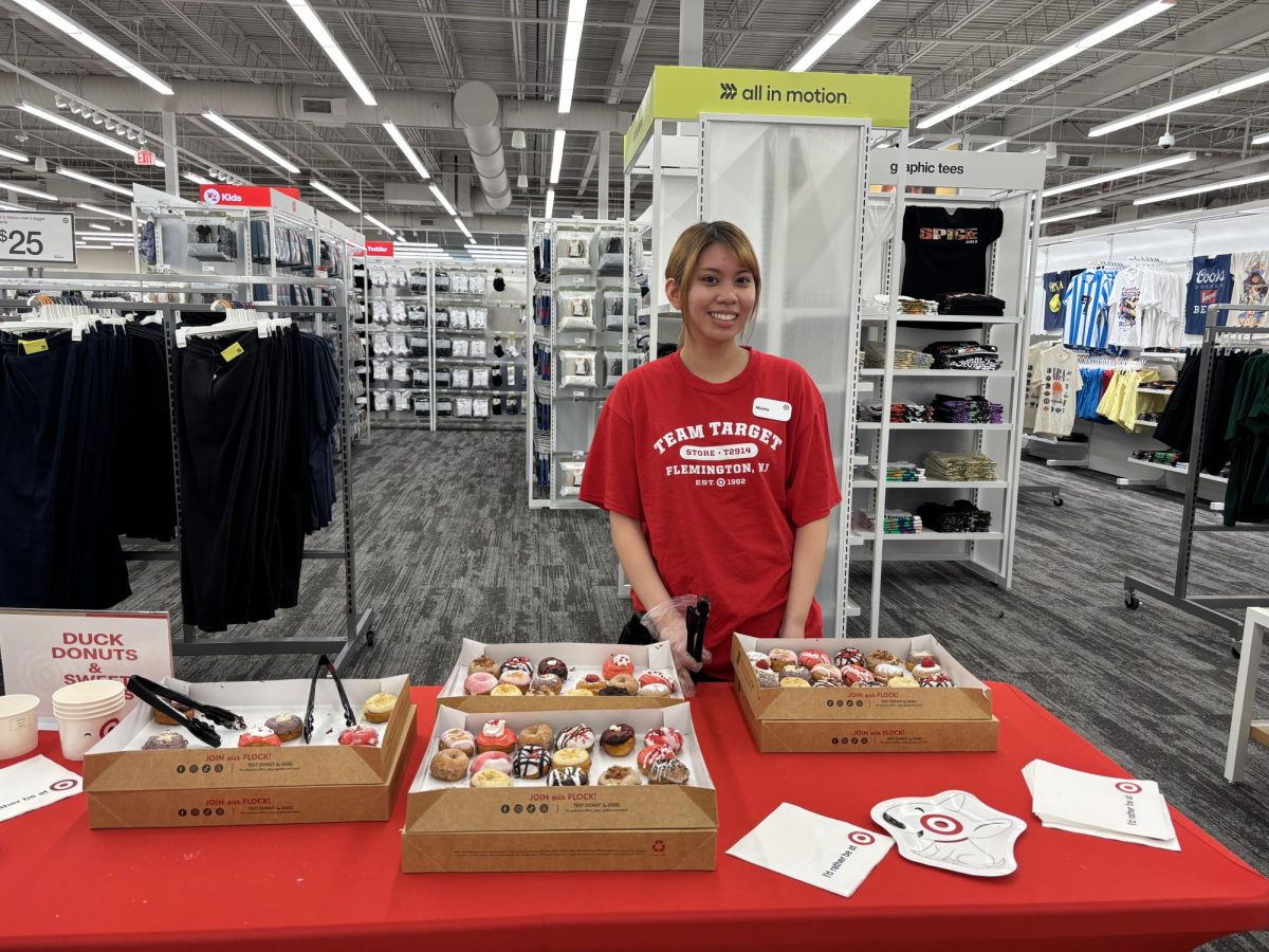Maddy, a member of the Target Team in Flemington, offers free Duck Donuts to soft opening visitors.  
