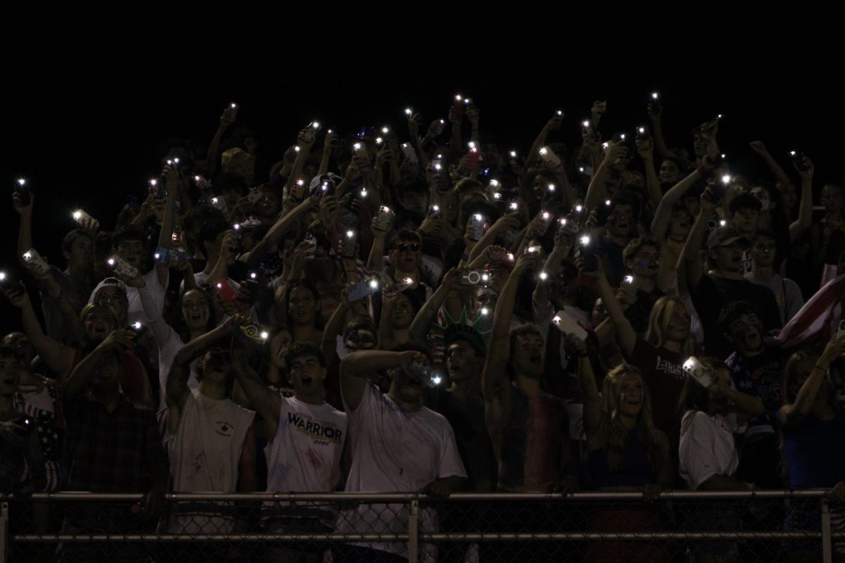 The Del Val Dawg Pound celebrates touchdown with the classic tradition of using phone flashlights to encourage the team into victory.