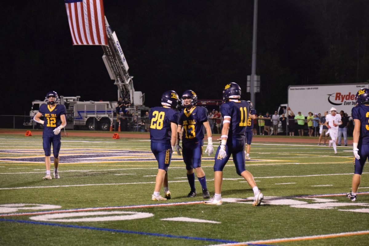 Del Val football players Evan Strochak (left), Lhiam Murphy (Center) and Brayden Picardo-Leask (Right) celebrate after a long pass completion.