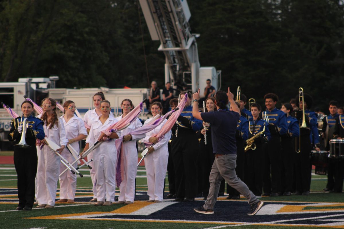Mr. Haiden leads marching band as they beautifully play during half time.  