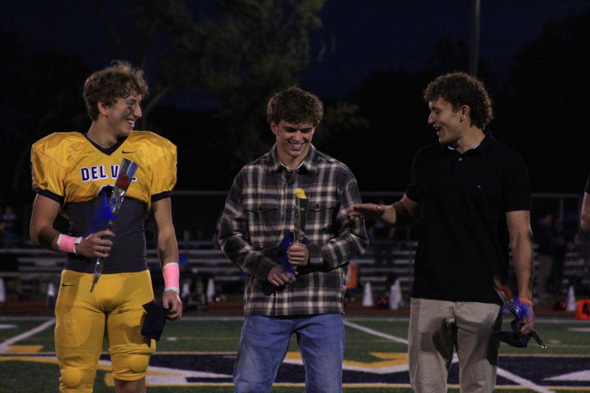 Homecoming King nominees, Marcus Gaspari and Vincent Casagrande, cheer on Tye Falkenstein as he realizes he won. Falkenstein and Lilly Rynearson were crowned this year's Homecoming King and Queen.