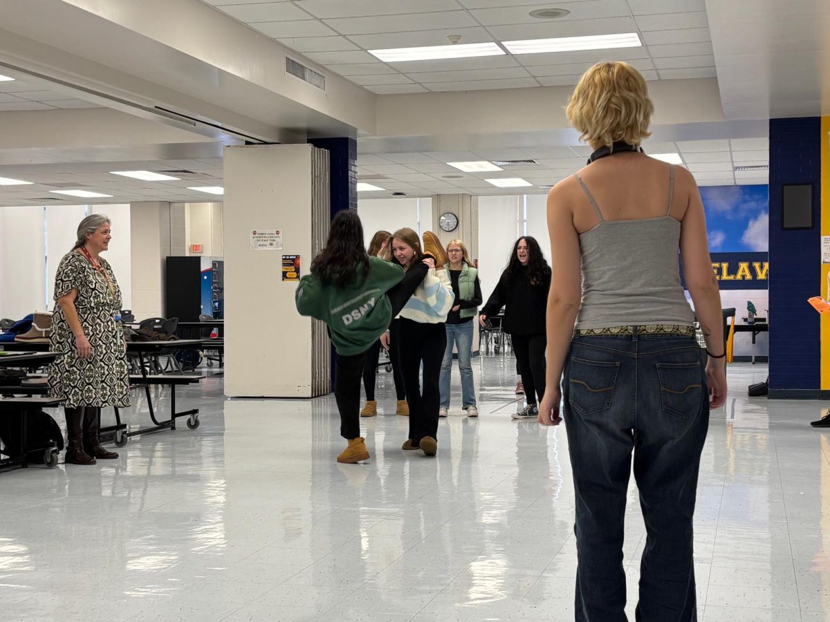 Students rehearse a scene for the upcoming fall play during rehearsal in the cafeteria.