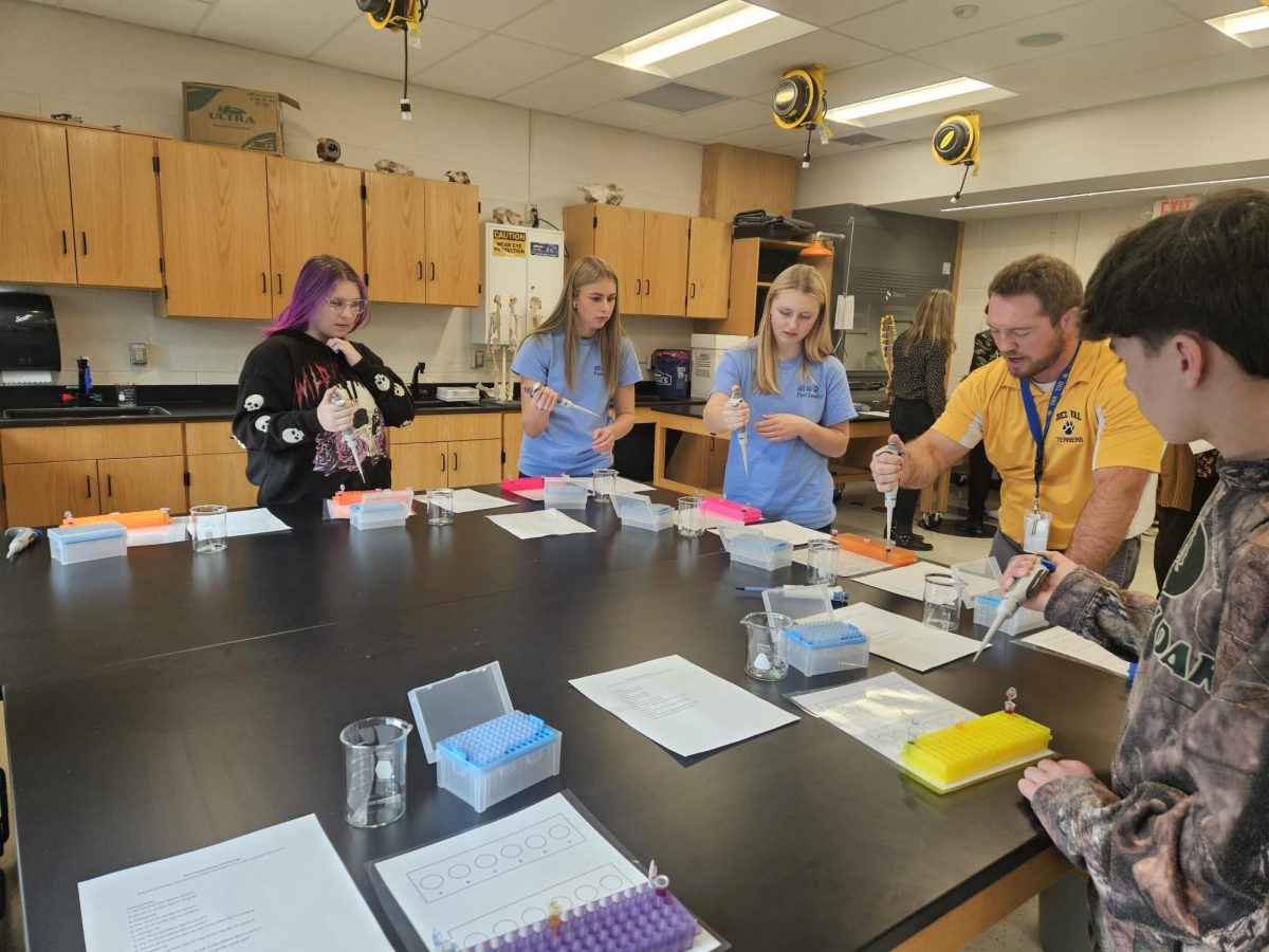 Students in the Peer Leaders club help eighth graders at the biomedical academy session during their visit to Del Val. The standardized club schedule allowed all Peers to attend the planning meeting before the visit.