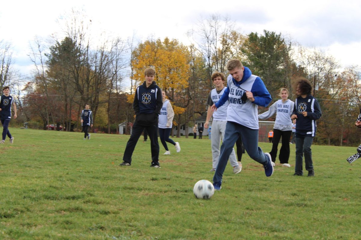 Freshman Unified soccer player Max Schwartz drives the ball down the field in the second half of the game. The Unified-Buddies soccer game has become an annual celebration of the end of the soccer season and a start to the holidays.