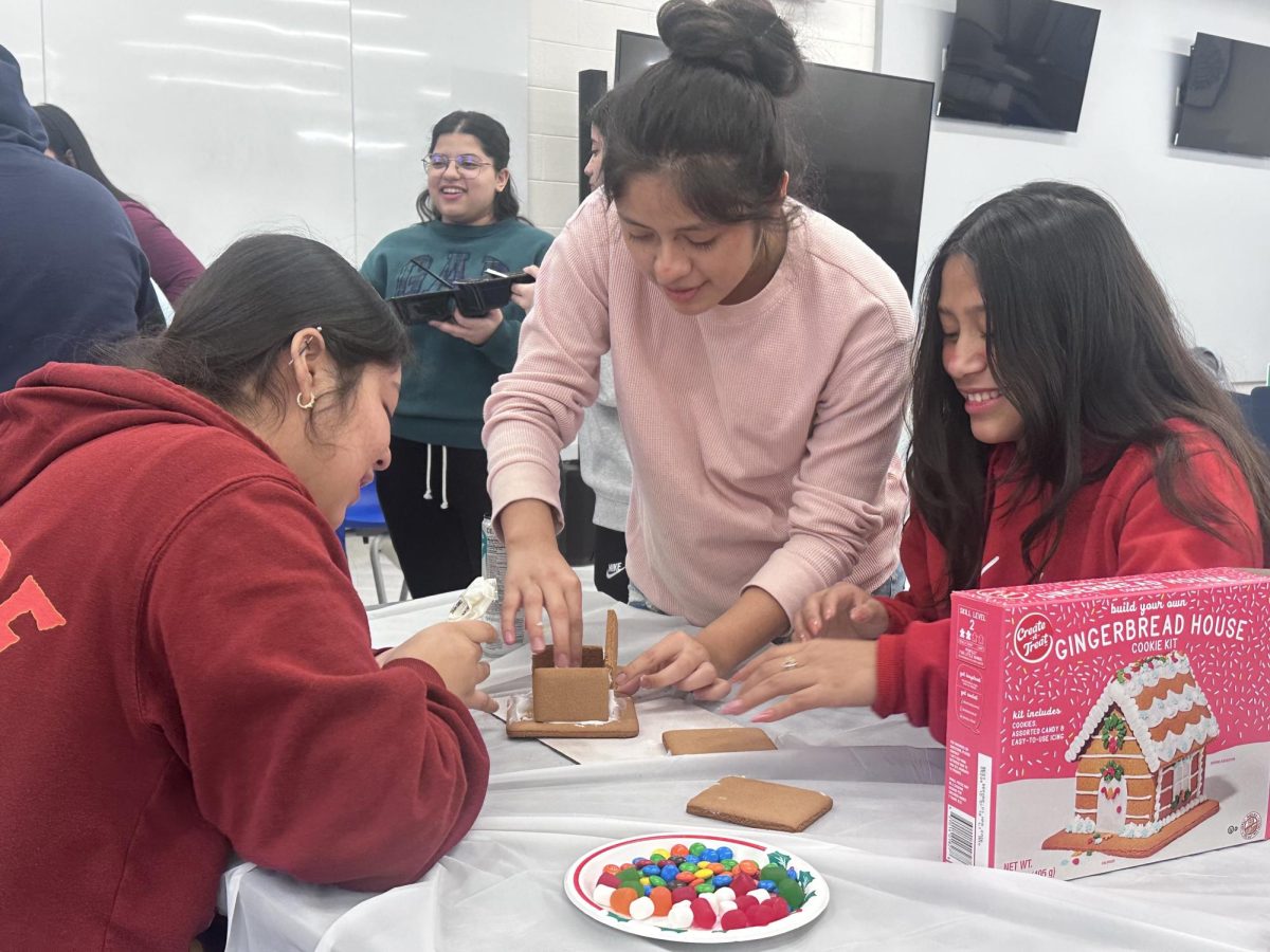 A team consisting of Britney Pena Guevara, Camila Pena Guevara and Marelyn Agustin worked on their gingerbread house design for Korea.