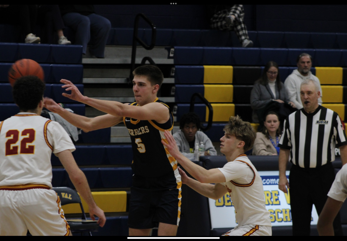 Chase Kraucheunos passes the basketball to a fellow player. Their teamwork throughout youth night was a highlight of the game.