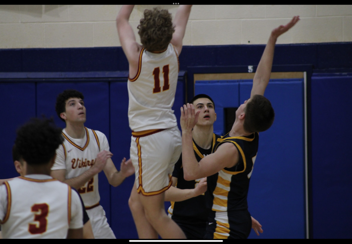 Varsity basketball players Peter Dubljevic and Chase Kraucheunos are seen playing defense. Chase was a starting player for youth night.
