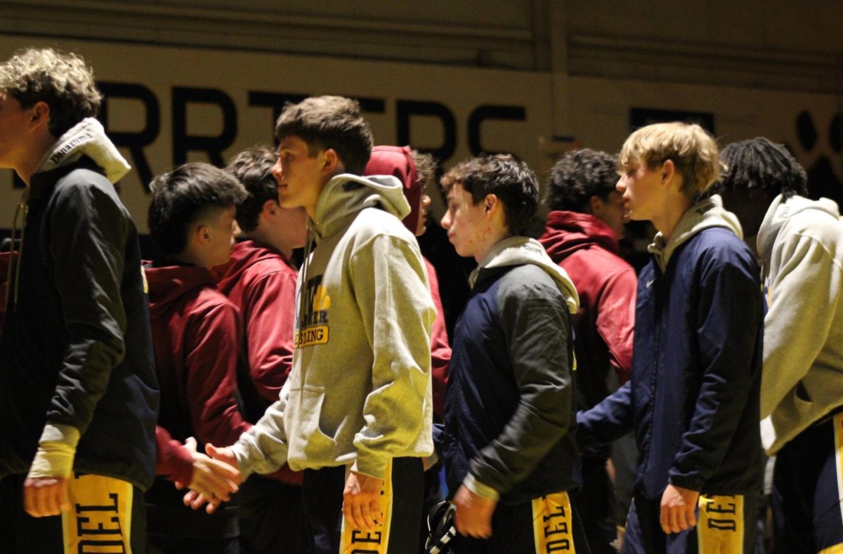 Del Val wrestlers shake hands with Pompton Lakes after match on Dec. 14, 2025.
