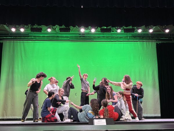 The cast of SpongeBob rehearsing “When the Going Gets Tough” after school on the auditorium stage. 