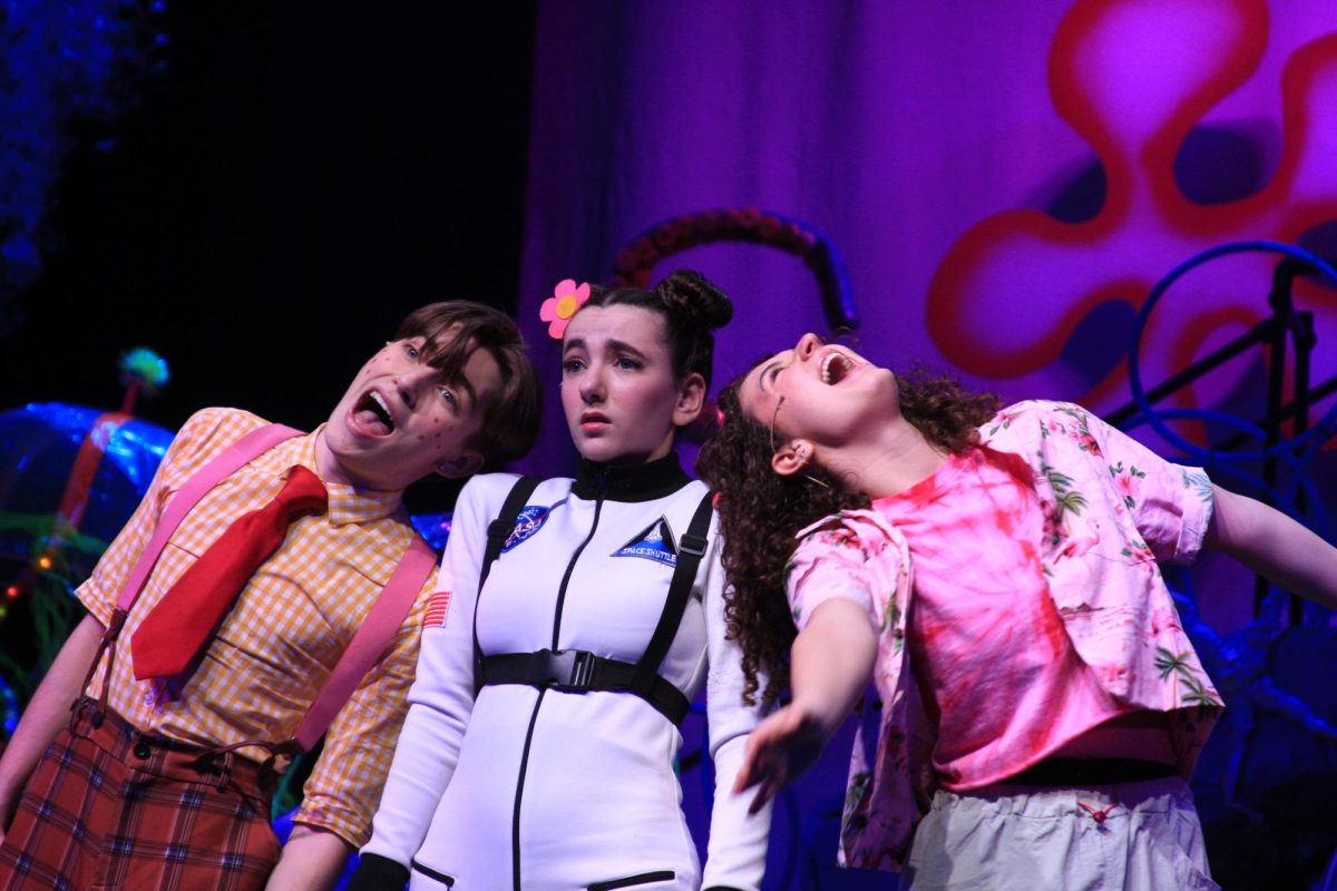 Alex Apgar as SpongeBob (left), Abigail Drake as Sandy Cheeks (center) and Lila Pfefferle as Patrick Star (right) light up the stage.