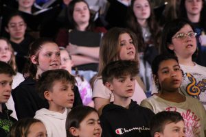 Young vocalists rehearsed with high schoolers to prepare for the night's performance. Sending district students visited Del Val to practice and bond with high school performing groups.