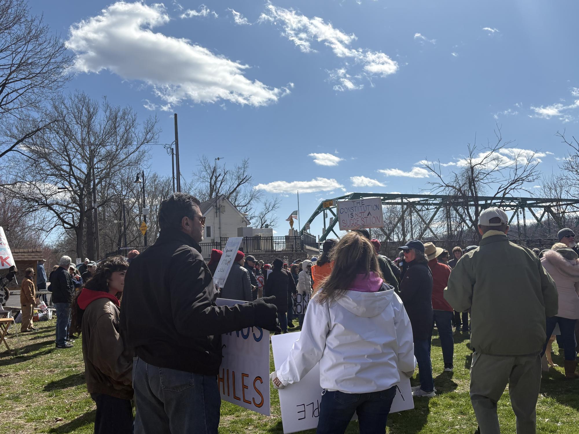 People gather in Sunbeam Park near the Frenchtown Bridge to hear opening remarks before the protest. There was roughly 40 minutes of speeches, music and prayers before the event began. 