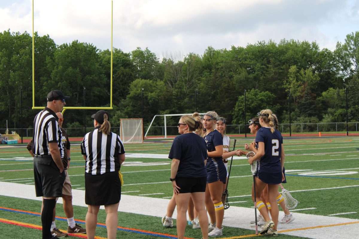 Referees interact with the girls' lacrosse team cordially. This was just moments before havoc struck. 