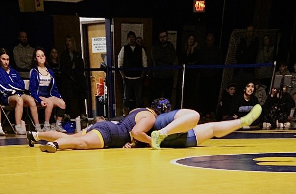 Emmy Rea Hotz pins her opponent at the team's home match.  Rea Hotz fell short of a post season championship, but she is motivated to wrestle even better next year.