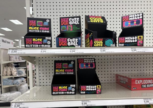A shelf of NeeDoh boxes sits empty on a Target shelf. The NeeDoh craze has affected every part of the country, due to factors like the internet, clout and retail therapy.