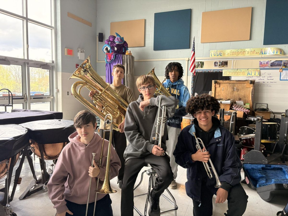 The brass quintet includes Levi Buzckowski and Luciano Zeppieri in the front. Baxter Vitale and Rohan Calliste positioned behind Tyler Crowl.