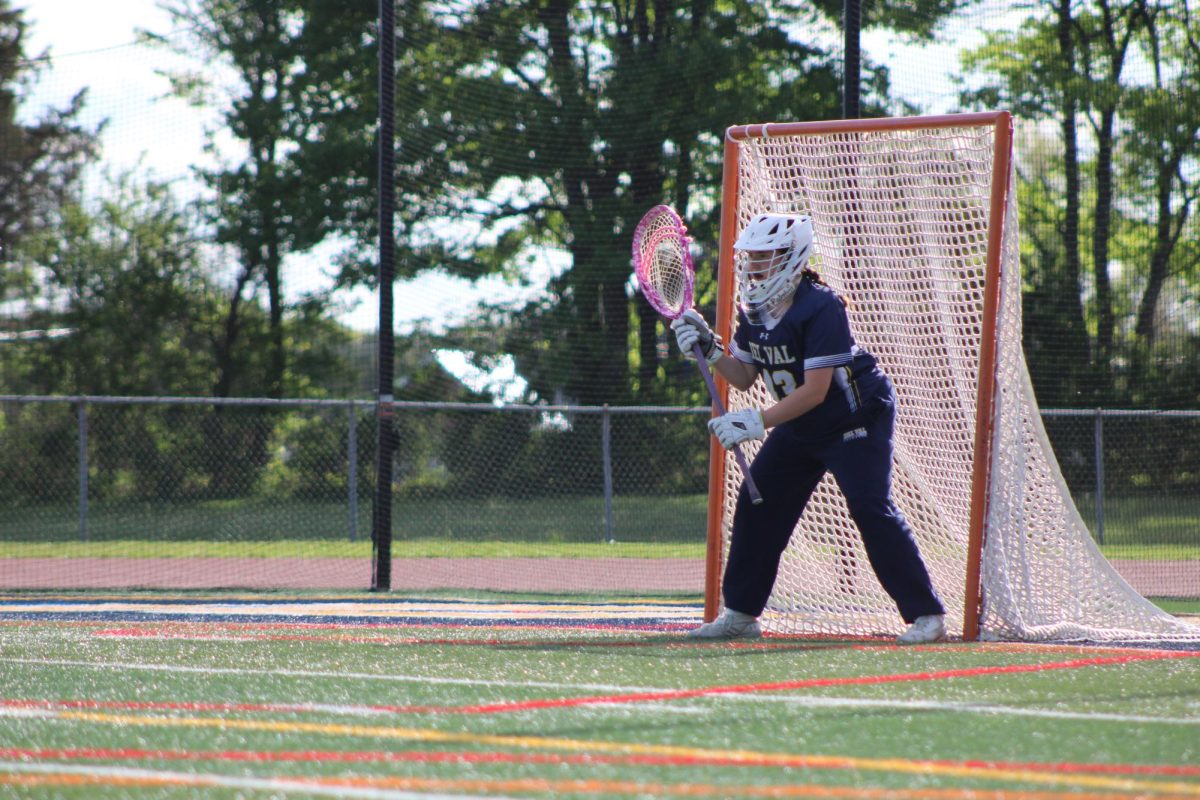 Senior Gwen Taffera stands ready at the goal during a lacrosse match against Voorhees. Taffera has been playing lacrosse for twelve years, four as a goalie.