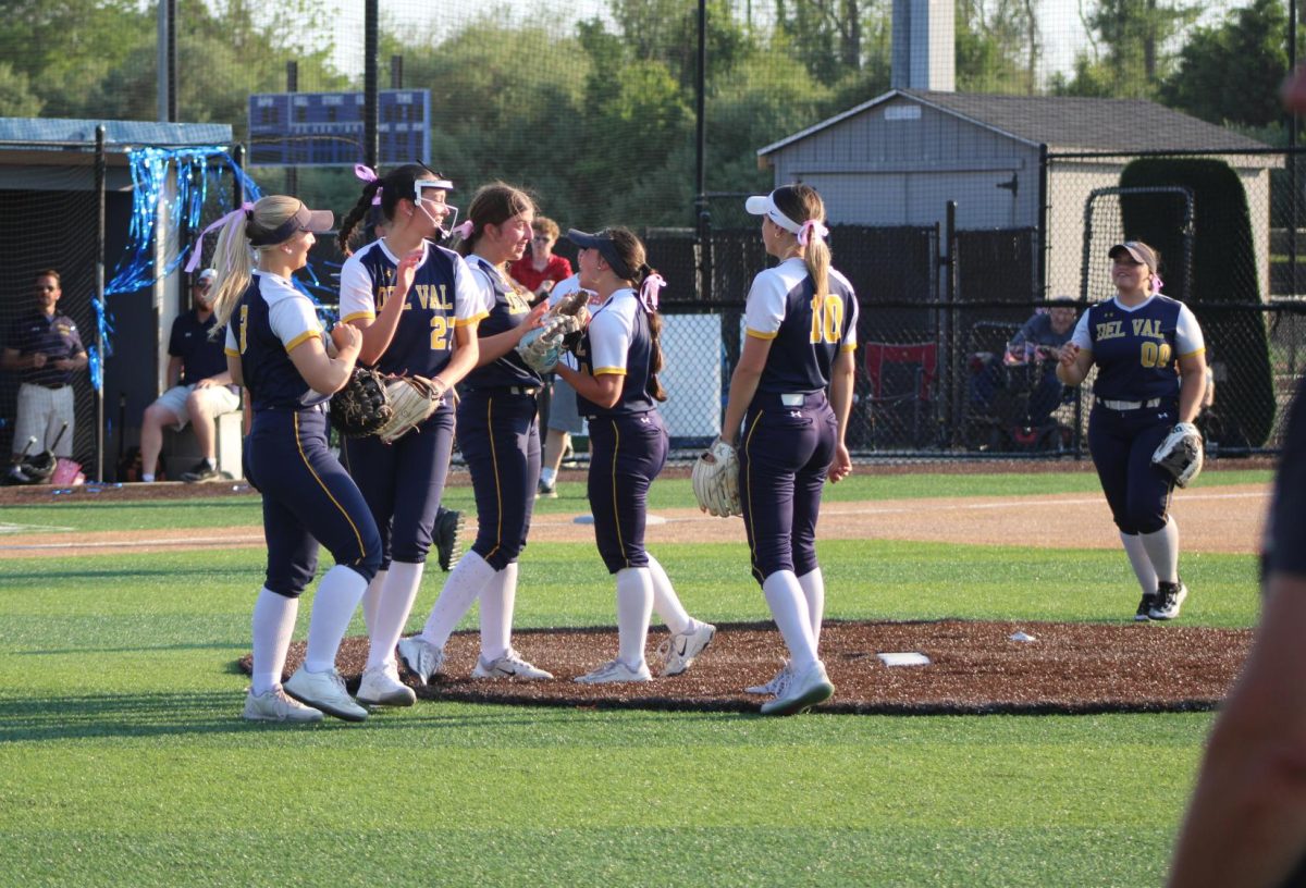 The team celebrates getting their first out against Hackettstown. Del Val wins with a score of 7-0.