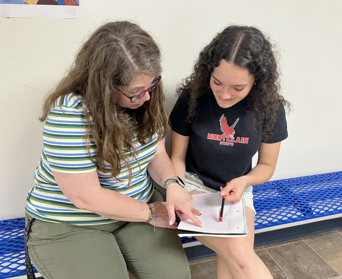 Cadence Wojcik works on an environmental science assignment with the help of teacher Stacy Grady. Wojcik noted Grady as one of her biggest supporters throughout her high school career.