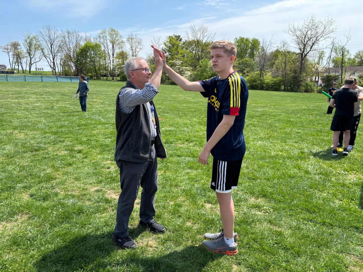 Mr. Lowe gives high fives for hard work after a tough soccer match. Lowe is known for supporting his students in all aspects of their academic and athletic lives.
