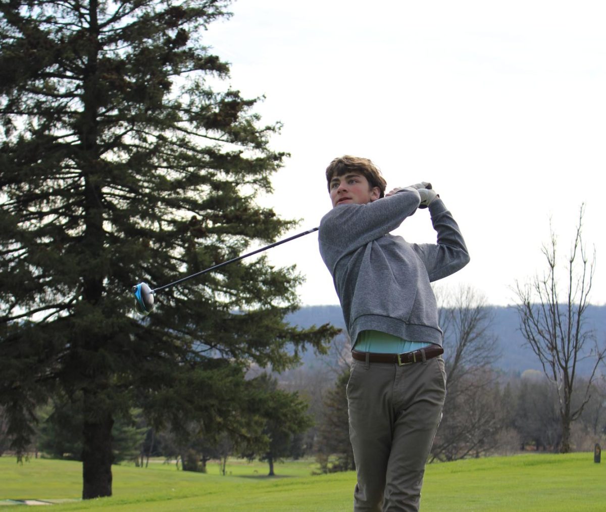 Junior Amel Bontempo watches as his ball flys through the air after he hit it. Amel is a returning member of the boys golf team. 