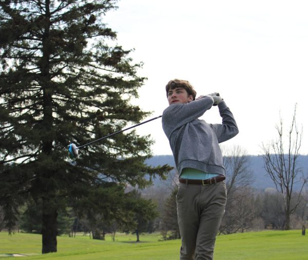 Junior Amel Bontempo watches as his ball flys through the air after he hit it. Amel is a returning member of the boys golf team.