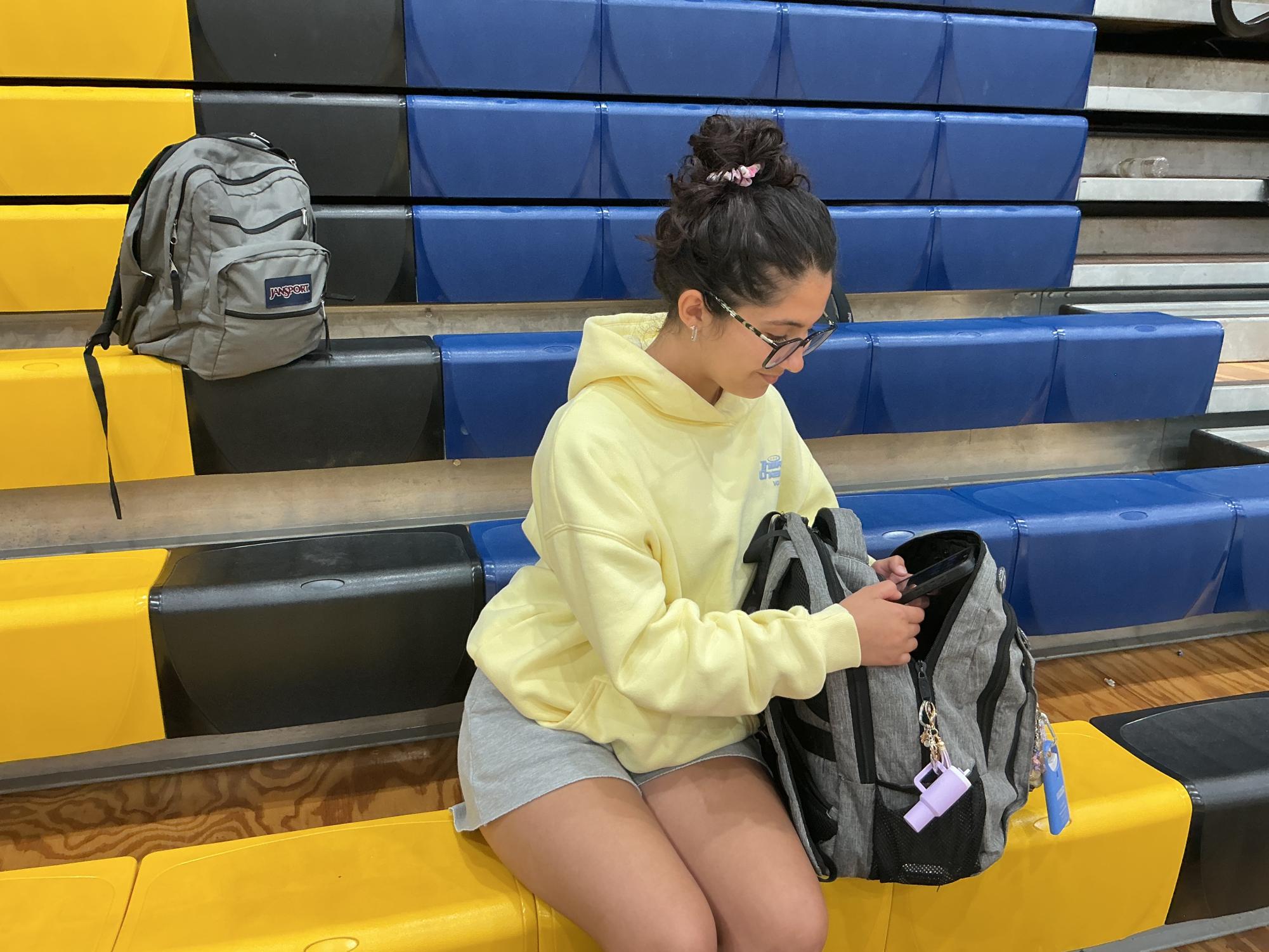 A Del Val sophomore hides her cellphone in her backpack in response to the cellphone restrictions. Administrators said students are expected to follow the policy, and visible violations may result in disciplinary consequences.
